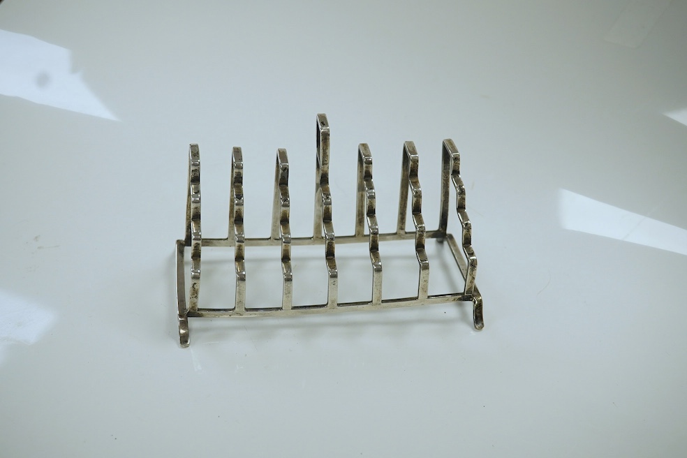 An unusual George V stepped silver seven bar toast rack, by A L Davenport Ltd, Birmingham, 1938, length 13.4cm. Condition - fair